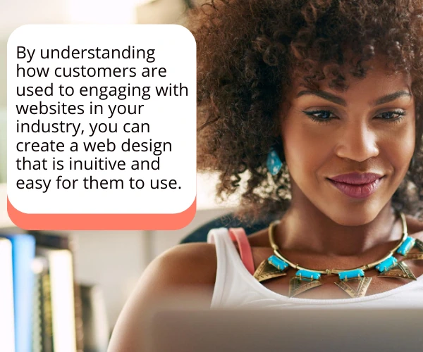Image of woman using a laptop, smiling at the screen, suggested that it's due to a great web design.