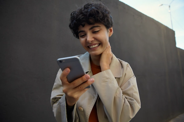 A woman is enjoying her experience on a phone app or website