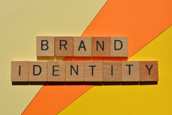 A trio of warm colors create a background for the words "brand identity"